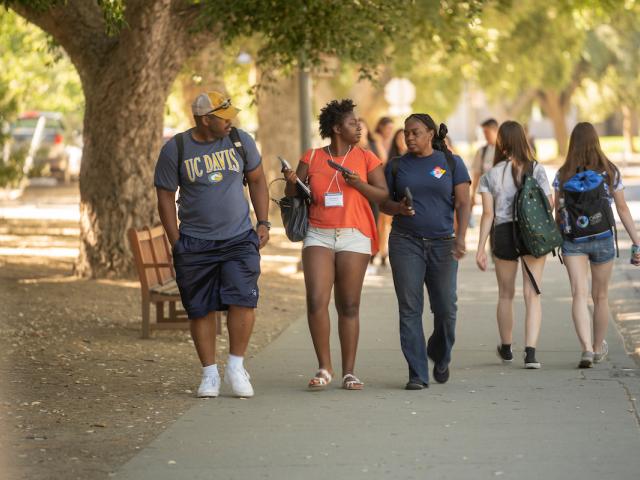 Family walks on campus during orientation.