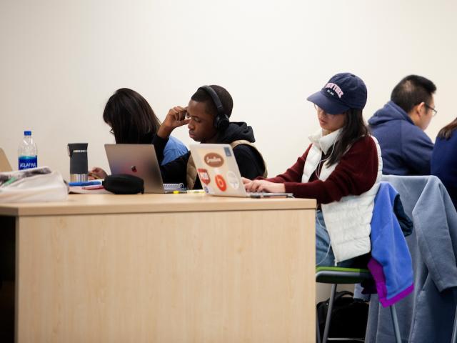 Students study in crowded library.