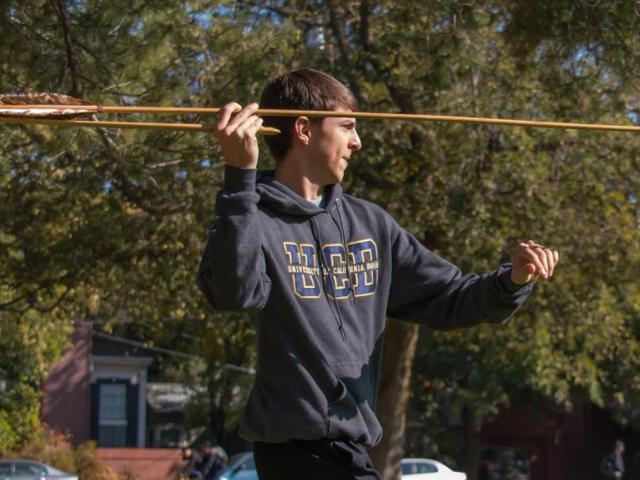 First-year student aiming arrow.