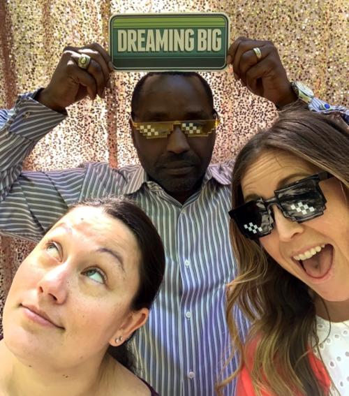 Andrea Duff, Kayton Carter, and Nicole Wood pictured, holding sign up that says, "Dream Big"