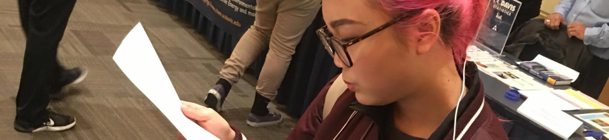 Student navigating through majors fair.