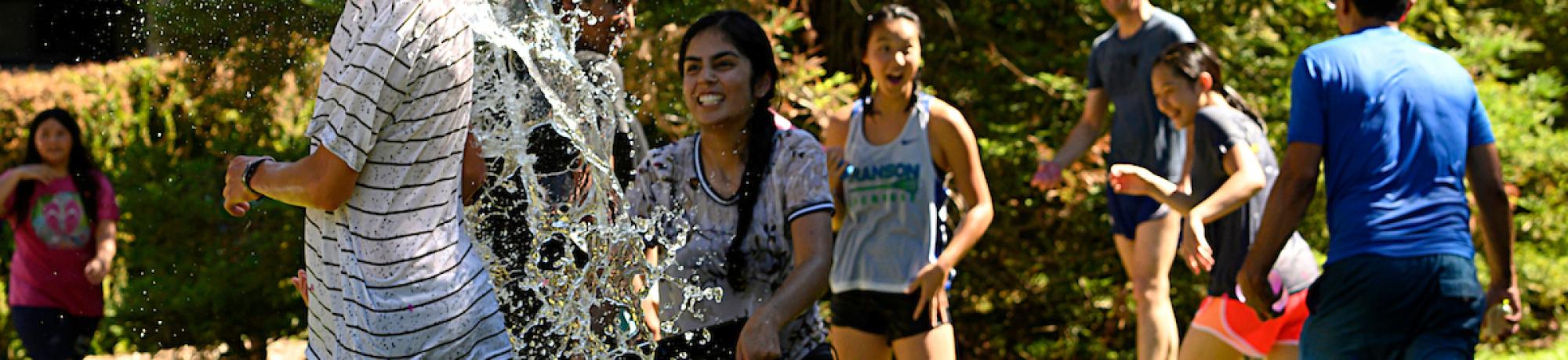 Students in a water balloon fight.