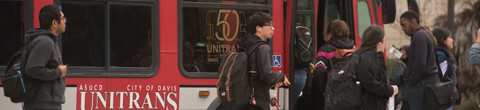 Passengers boarding Unitrans bus.